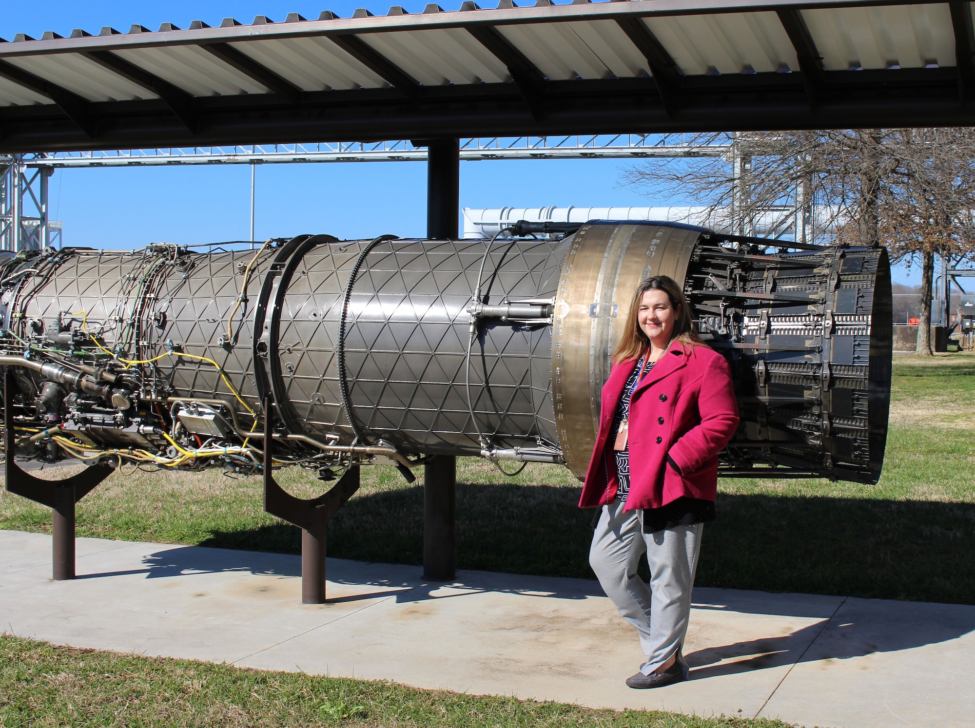 Melissa Tate stands outside the Engine Test Facility at Arnold Air Force Base.