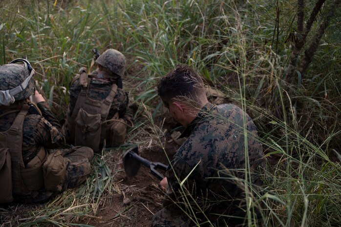U.S. Marines with Marine Wing Support Squadron 174 dig fighting holes in a training exercise at Marine Corps Training Area Bellows, March 2, 2022. The training exercise was conducted to produce readiness, preparing operating forces to deploy at a moment’s notice. (U.S. Marine Corps photo by Lance Cpl. Isaiah Hill)