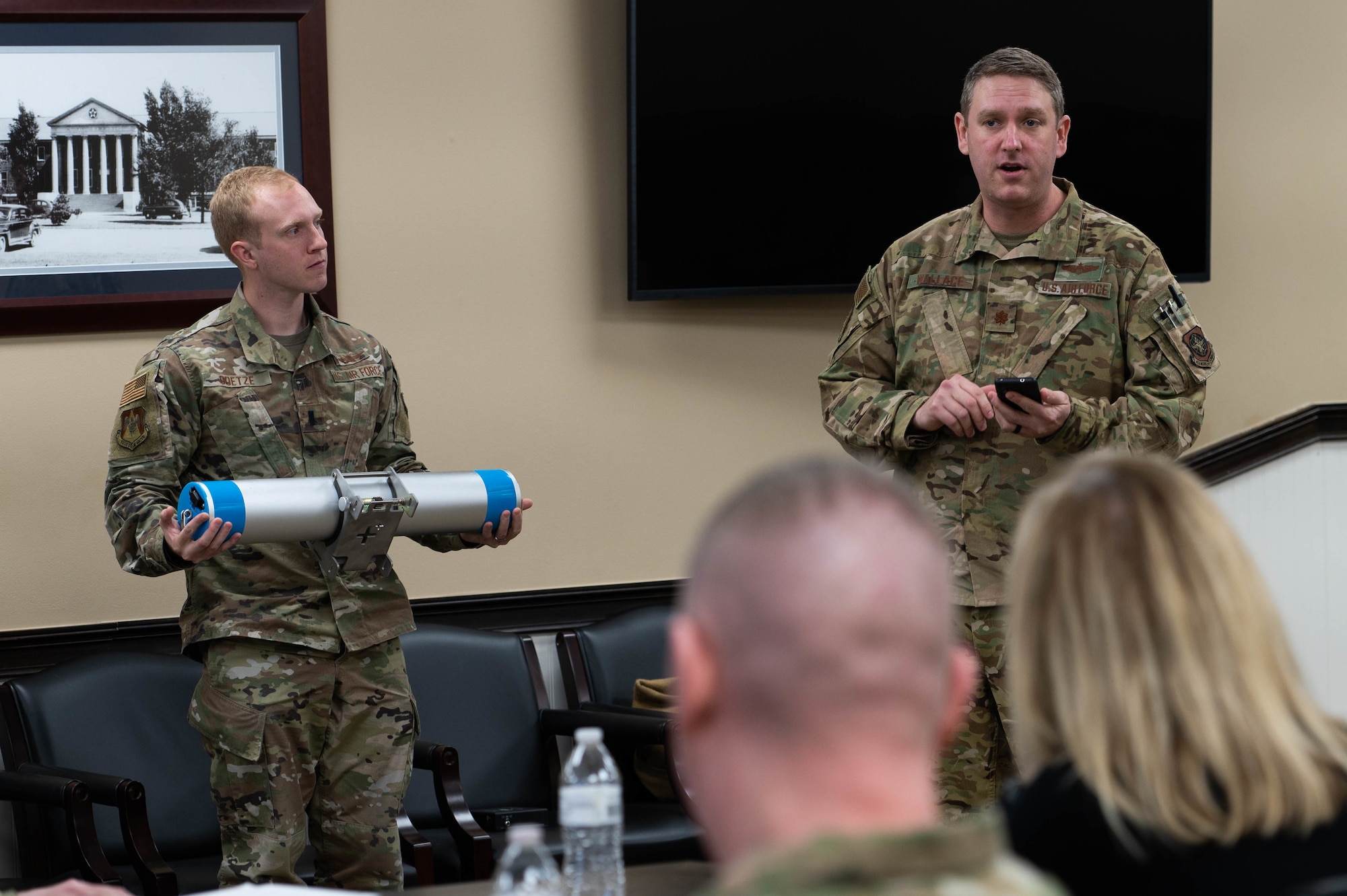 From left, U.S. Air Force 1st Lt. Thomas Goetze, 375th Air Mobility Wing deputy innovation officer, and Maj. Adam Wallace, 375th AMW chief innovation officer, brief 18th Air Force senior leadership about the spark cell, ELEVATE, and it’s potential to help emergency communication at Scott Air Force Base, Illinois, March 9, 2022. Team Elevate is office on base focused on solving airmen issues with innovated solutions. (U.S. Air Force photo by Airman 1st Class Mark Sulaica)