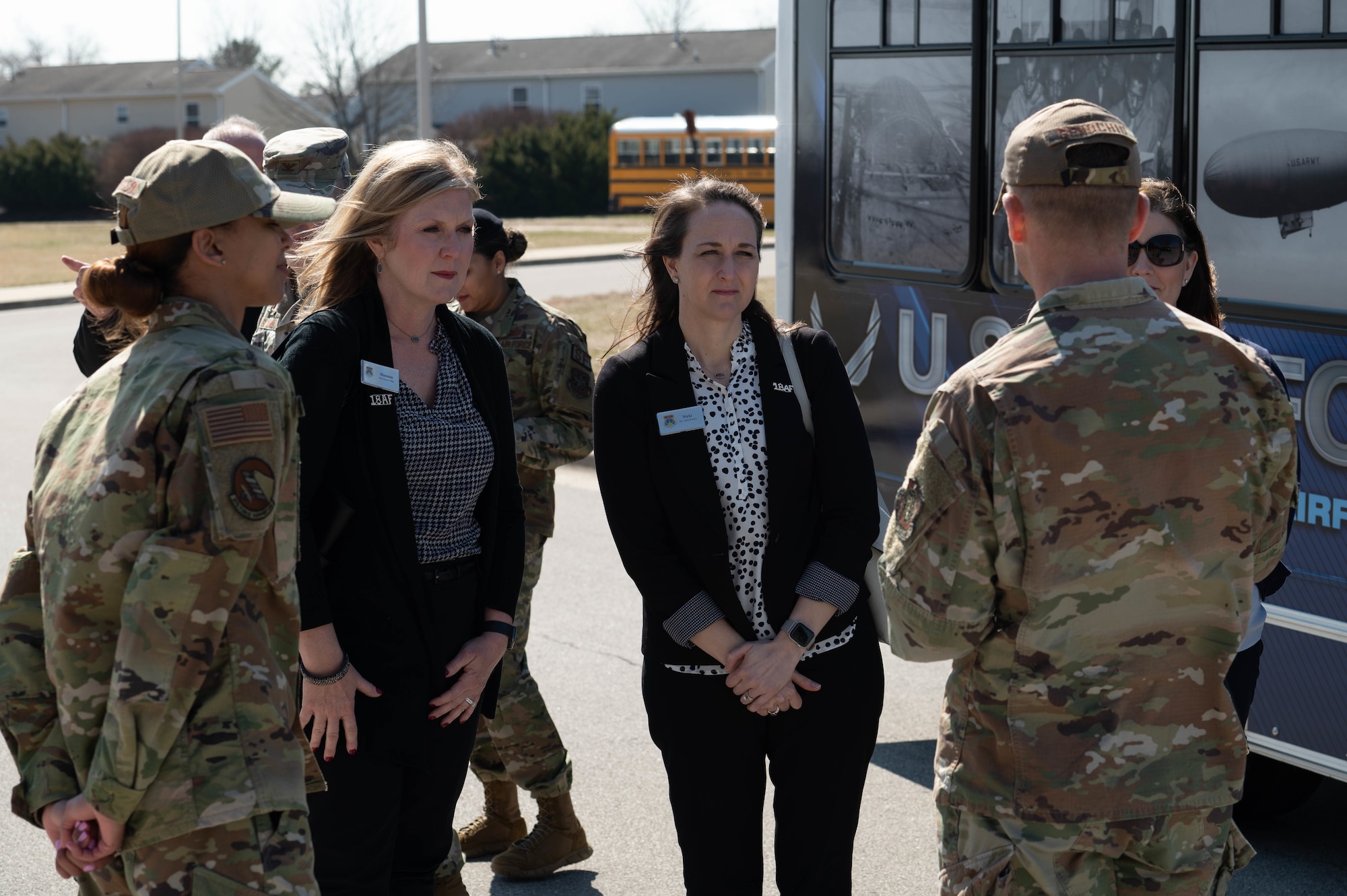 Servicemembers from team Scott greet Mrs. Shannon Bibb and Mrs. Nicki Bickley, 18th Air Force senior leadership spouses, outside the Youth Center on Scott Air Force Base, Illinois, March 9, 2022.  Servicemembers hosted a forum to discuss the impacts and talent management of dual Department of Defense career families with Mrs. Bibb and Mrs. Bickley. (U.S. Air Force photo by Airman 1st Class Mark Sulaica)