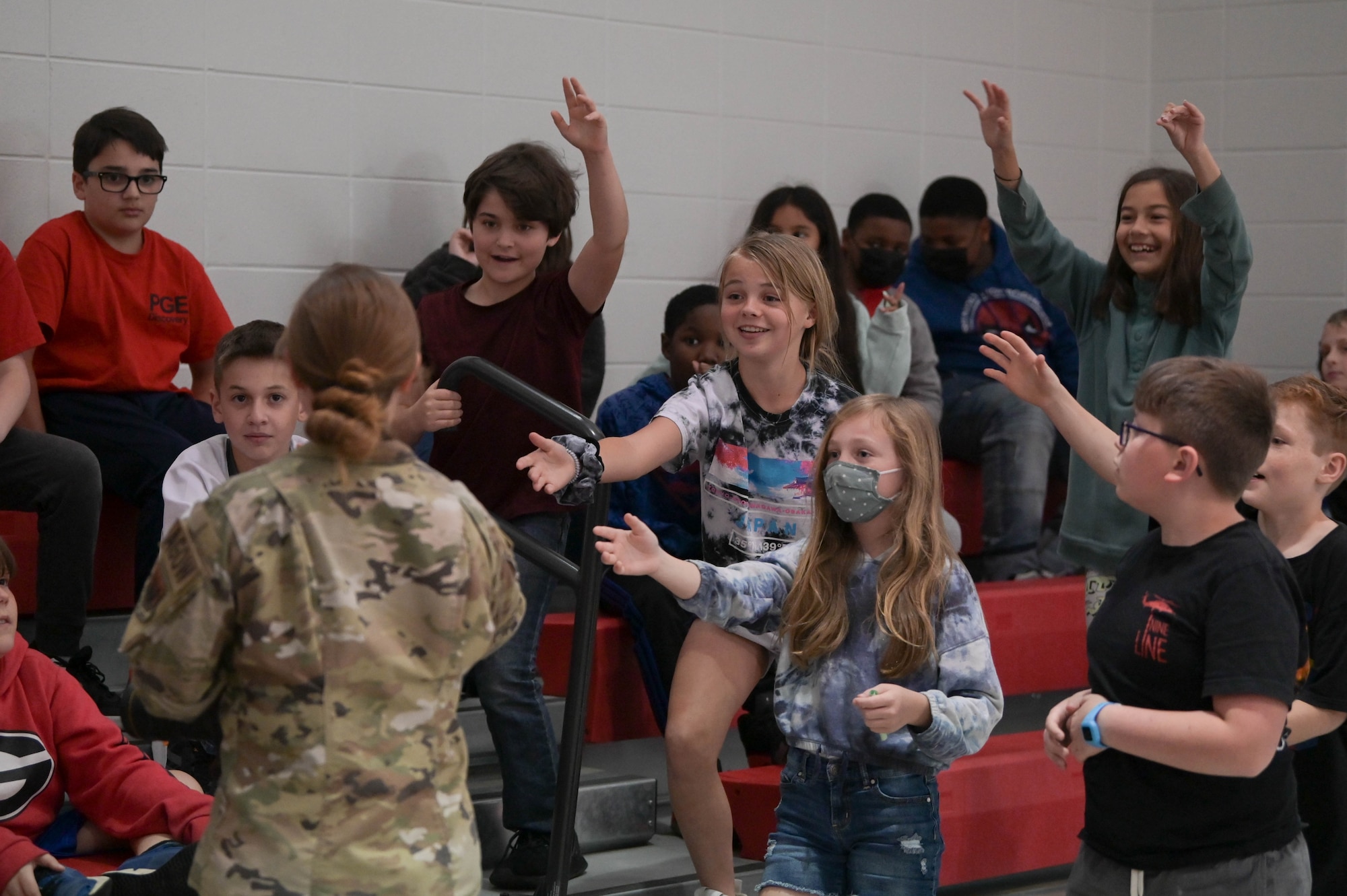 U.S. Air Force 1st Lt. Katie Tamesis, 93rd Air Ground Operations Wing public affairs officer, hands out 93rd AGOW stickers to Elementary students, March 10, 2022, at Pine Grove Elementary School, Valdosta, Georgia. Engaging with the schools gave Team Moody the opportunity to showcase the many career fields that make up the Air Force. (U.S. Air Force photo by Senior Airman Rebeckah Medeiros)