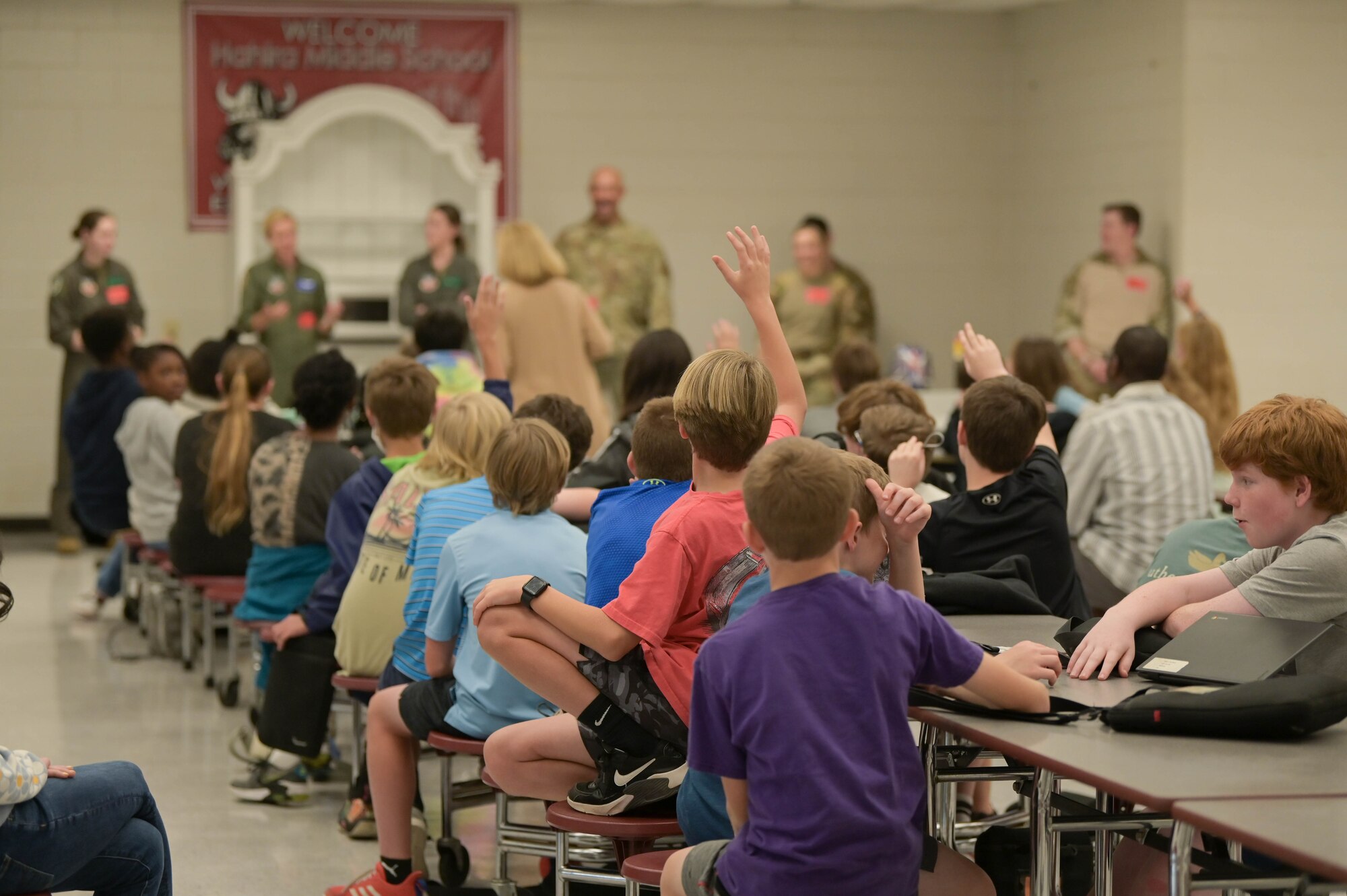 Children raise their hands to ask Moody’s team questions, March 10, 2022, at Hahira Middle School, Valdosta, Georgia. Students ranging from fifth grade to twelfth grade had the chance to meet 10 service members and hear their various experiences in the military. (U.S. Air Force photo by Senior Airman Rebeckah Medeiros)