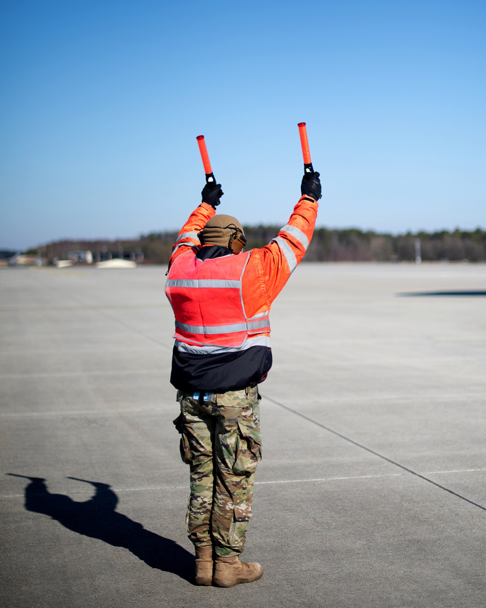 U.S. Air Force Senior Airman Dakota Woods, 726th Air Mobility Squadron, aircraft electrical and environmental systems journeyman, marshals a U.S. Air Force C-5M Super Galaxy aircraft, Mar. 7, 2022 on Spangdahlem Air Base, Germany.