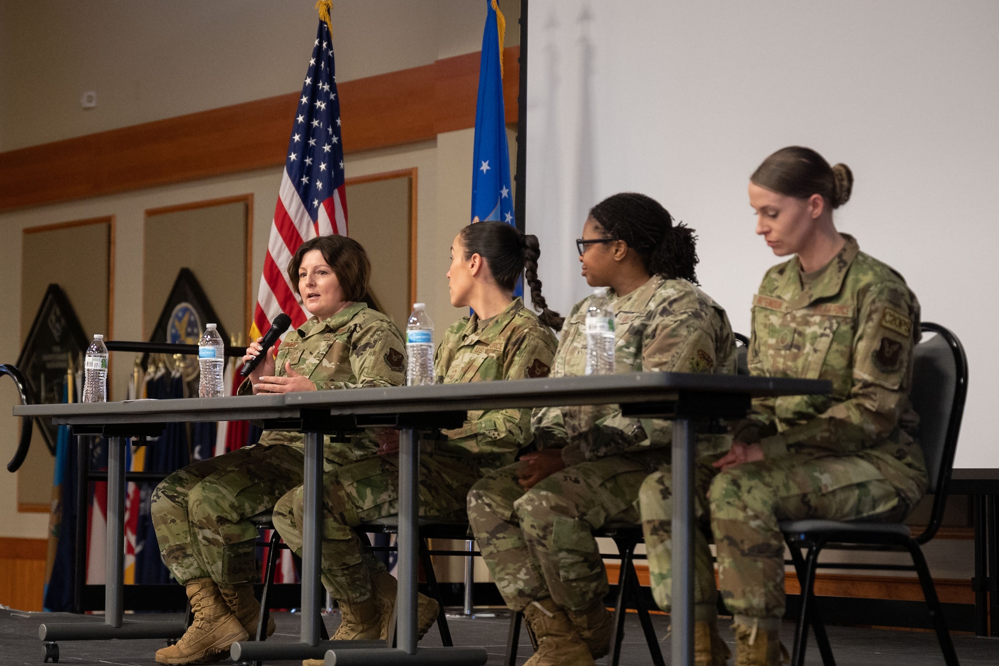 Chief Master Sgt. Kristi Binard, 341st Medical Group superintendent, left, speaks during a Women’s History Month Symposium leadership panel March 10, 2022, at Malmstrom Air Force Base, Mont.