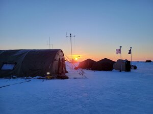 The sun sets over Ice Camp Queenfish during the Navy's Ice Exercise (ICEX) 2022.