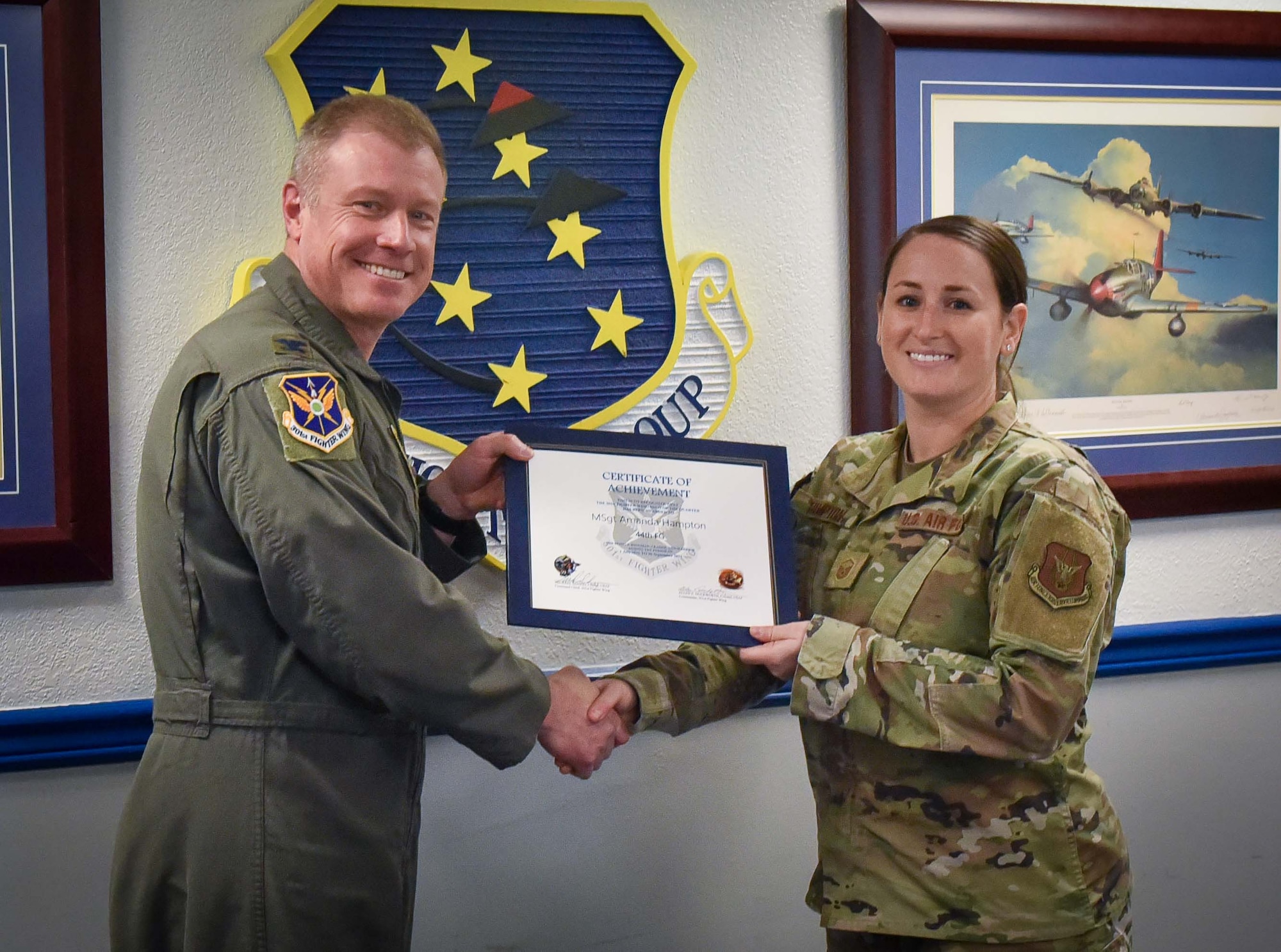 (left) 301st Fighter Wing Commander Col. Allen Duckworth recognizes 301st Fighter Squadron Superintendent Master Sgt. Amanda Hampton during the wing's visit to the 44th Fighter Group at Eglin Air Force Base, Fla., March 4. She was selected as the 44 FG Senior Non-Commissioned Officer of the Quarter for 3rd Quarter due to her skillset and preference to let others shine before herself. (U.S. Air Force photo by Master Sgt. Jeremy Roman)