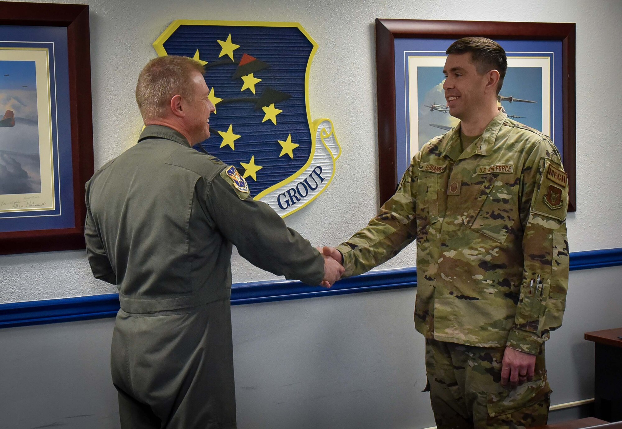 (left) 301st Fighter Wing Commander Col. Allen Duckworth gives his commander's coin to recognize Master Sgt. Derek Eubanks, 44 FG F-22 production superintendent during the wing's visit to the 44 FG at Eglin Air Force Base, Fla., March 4.
Eubanks is responsible for all flight line maintenance actions and sortie generation. Over the past four months, he has strengthened the group’s relationship with the 325th Fighter Wing, Air Combat Command, Eglin AFB, Fla., by the actions he and his team have done to provide F-22 solutions while maintaining airframe excellence. (U.S. Air Force photo by Master Sgt. Jeremy Roman)