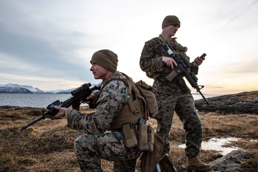 U.S. Marine Corps Lance Cpl. Jared Curtis (left), and Lance Cpl. Dylan Shawver, guard force sentries with 2d Marine Expeditionary Support Battalion, II Marine Expeditionary Force, pose with a portable handset enabled with PacStar Radio over Internet Protocol (RoIP) during Exercise Cold Response 2022, Bodo, Norway, March 9, 2022. PacStar RoIP is a critical communication capability which enables instantaneous and simultaneous two-way radio communication using local and worldwide internet networks. Exercise Cold Response '22 is a biennial Norwegian national readiness and defense exercise that takes place across Norway, with participation from each of its military services, as well as from 26 additional North Atlantic Treaty Organization allied nations and regional partners. (U.S. Marine Corps photo by Sgt. Megan Roses)