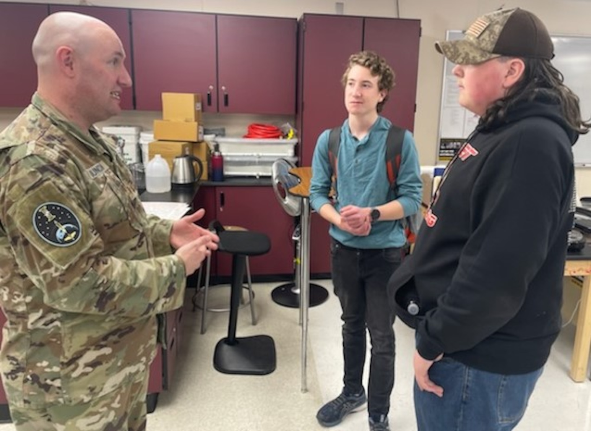 Space Force Major Taylor Duncan discusses Newton’s Laws and the Ideal Gas Law with students during a recent education outreach event.