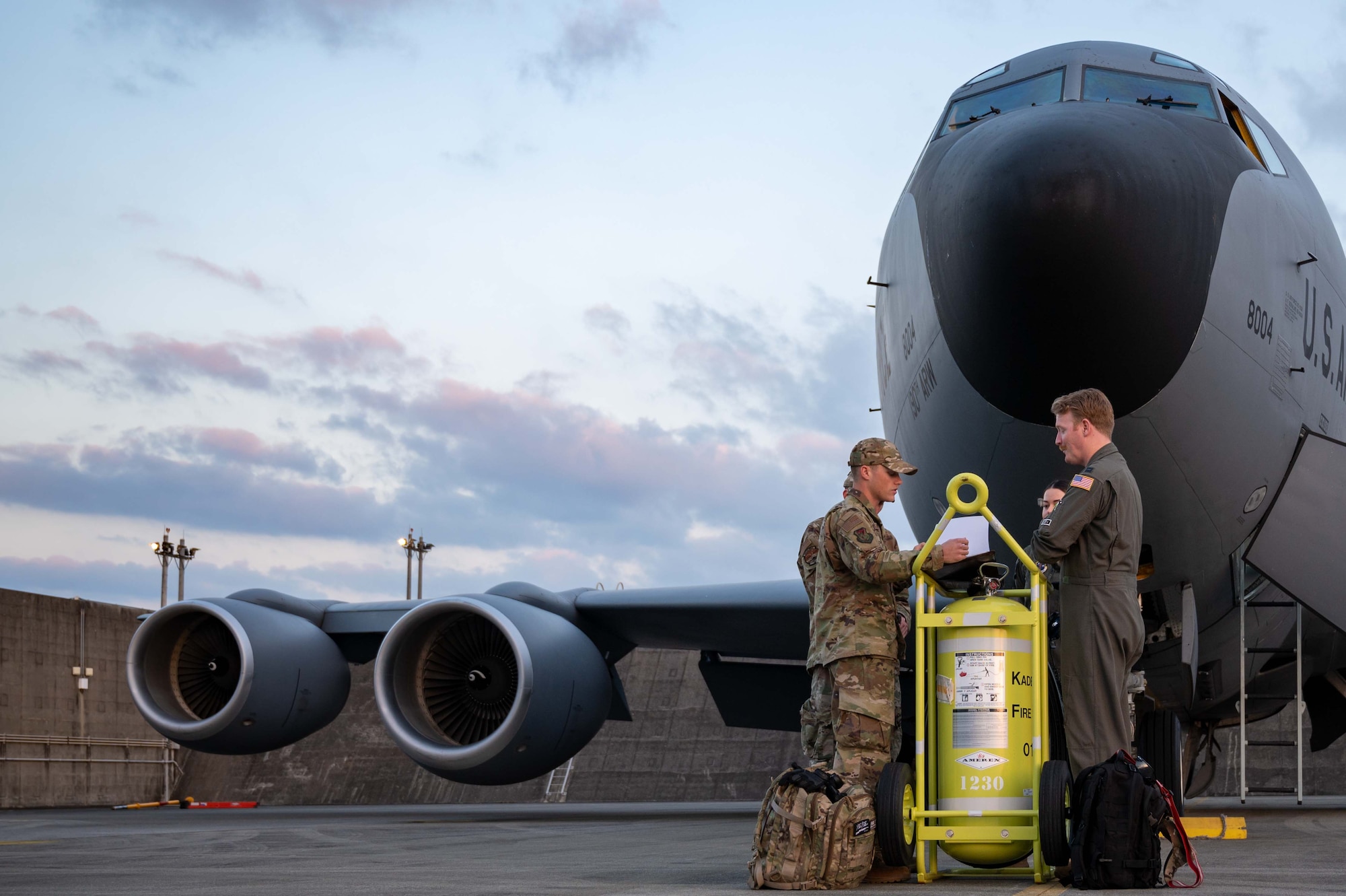 Airmen conduct preflight checks on an aircraft