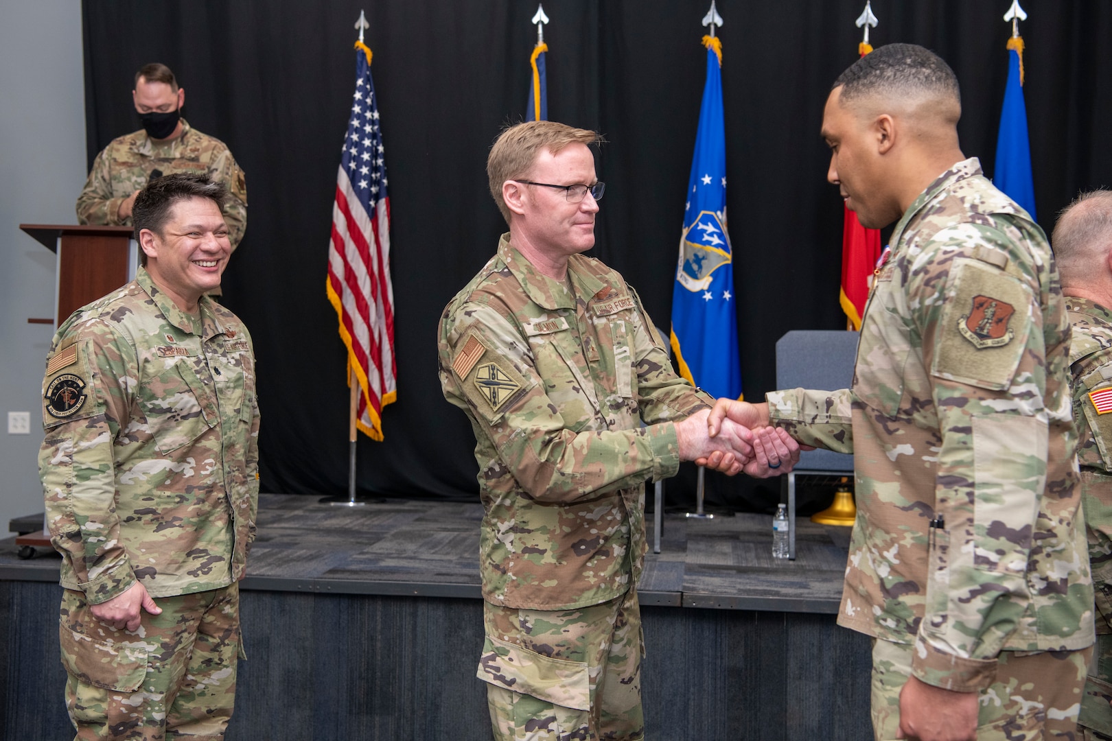 Brig. Gen. Bryan E. Salmon, the Assistant Adjutant General for Air National Guard Strategic Initiatives, shakes an Airman's hand at an end of mobilization ceremony Feb. 25, 2022, in Hampton, Virginia.