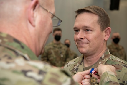 Maj. Gen. Timothy P. Williams, the Adjutant General of Virginia, presents Airmen with the Virginia Governor's National Service Medal at an end of mobilization ceremony Feb. 25, 2022, in Hampton, Virginia.