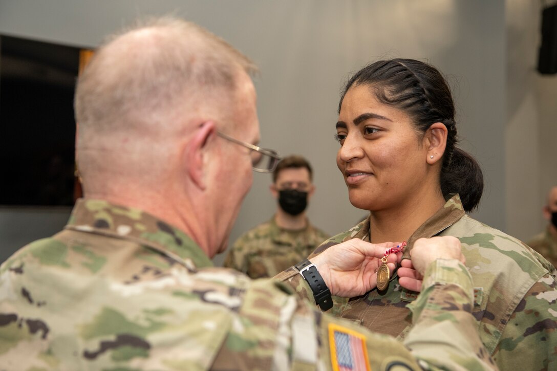 Maj. Gen. Timothy P. Williams, the Adjutant General of Virginia, presents Airmen with the Virginia Governor's National Service Medal at an end of mobilization ceremony Feb. 25, 2022, in Hampton, Virginia.