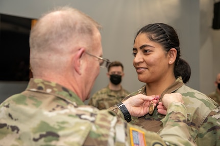 Maj. Gen. Timothy P. Williams, the Adjutant General of Virginia, presents Airmen with the Virginia Governor's National Service Medal at an end of mobilization ceremony Feb. 25, 2022, in Hampton, Virginia.