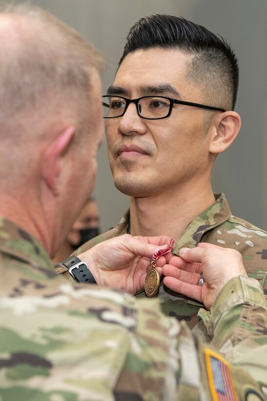 Maj. Gen. Timothy P. Williams, the Adjutant General of Virginia, presents Airmen with the Virginia Governor's National Service Medal at an end of mobilization ceremony Feb. 25, 2022, in Hampton, Virginia.