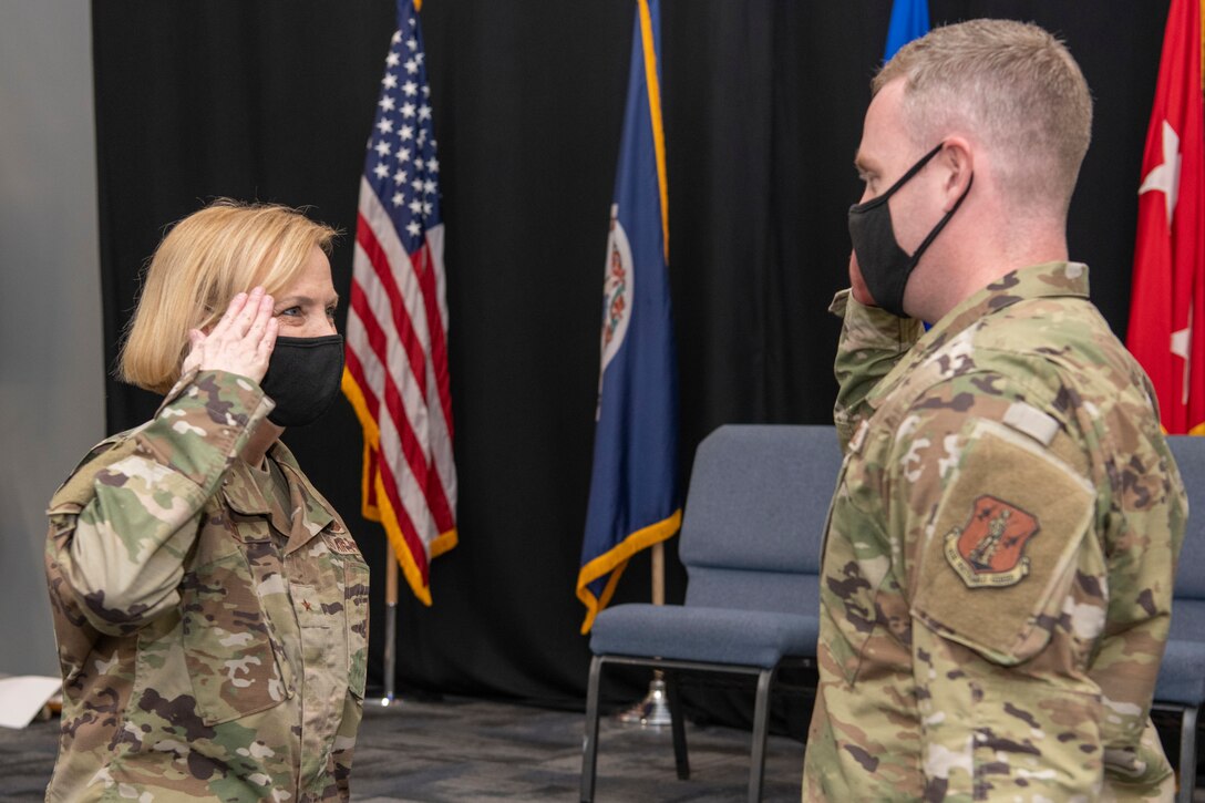 Brig. Gen. Toni M. Lord, Virginia National Guard air component commander, presents her challenge coin to members of the 856th Cyber Protection Team prior to an end of mobilization ceremony Feb. 25, 2022, in Hampton, Virginia.