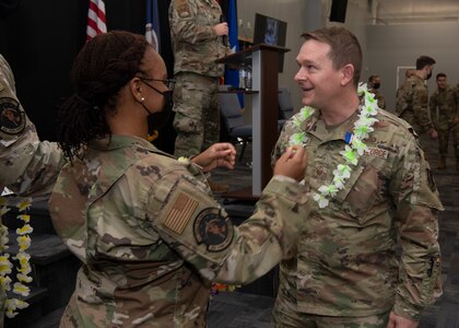An Airman is presented with a lei at an end of mobilization ceremony Feb. 25, 2022, in Hampton, Virginia.