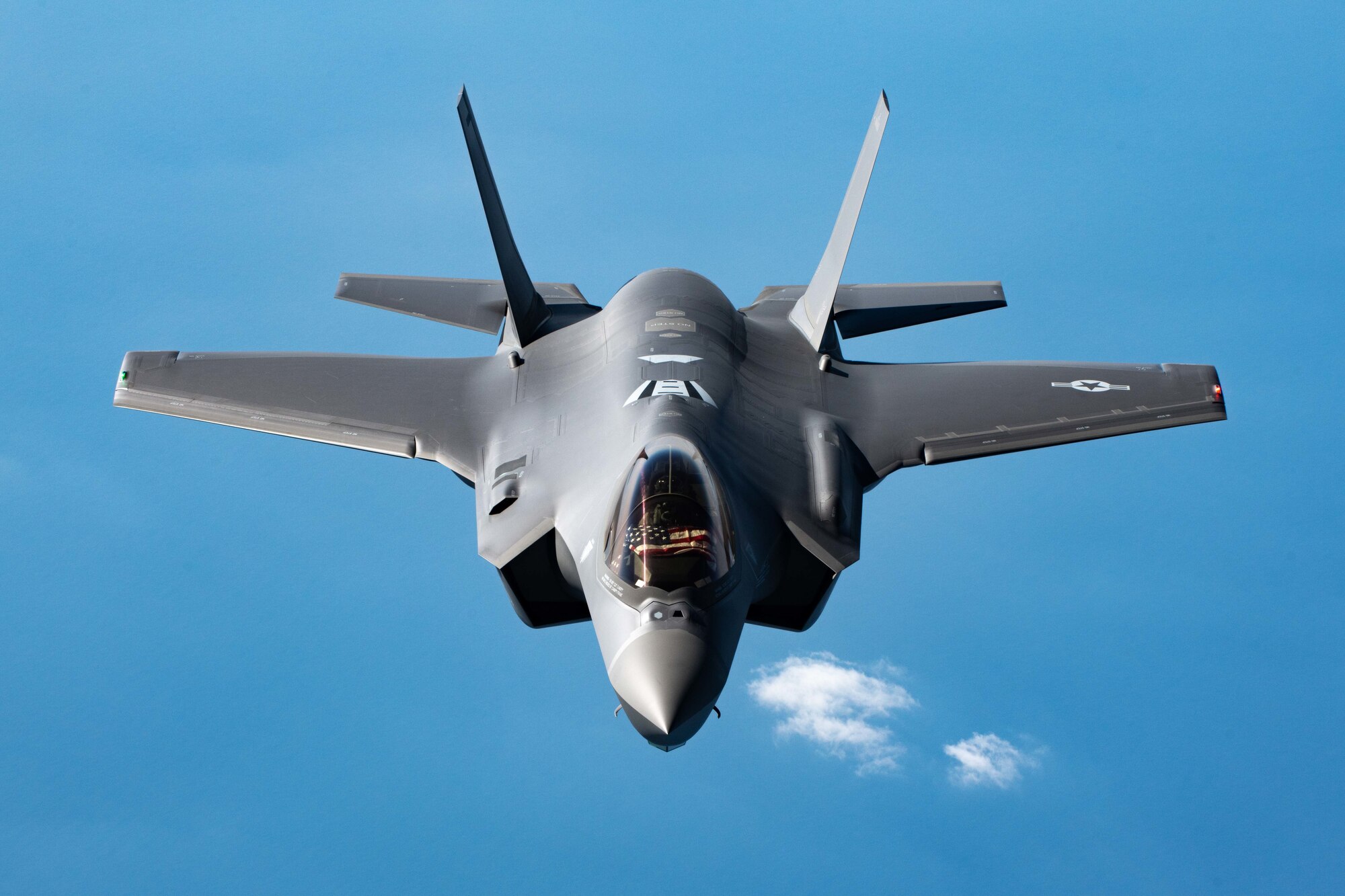 A jet flies behind an aircraft