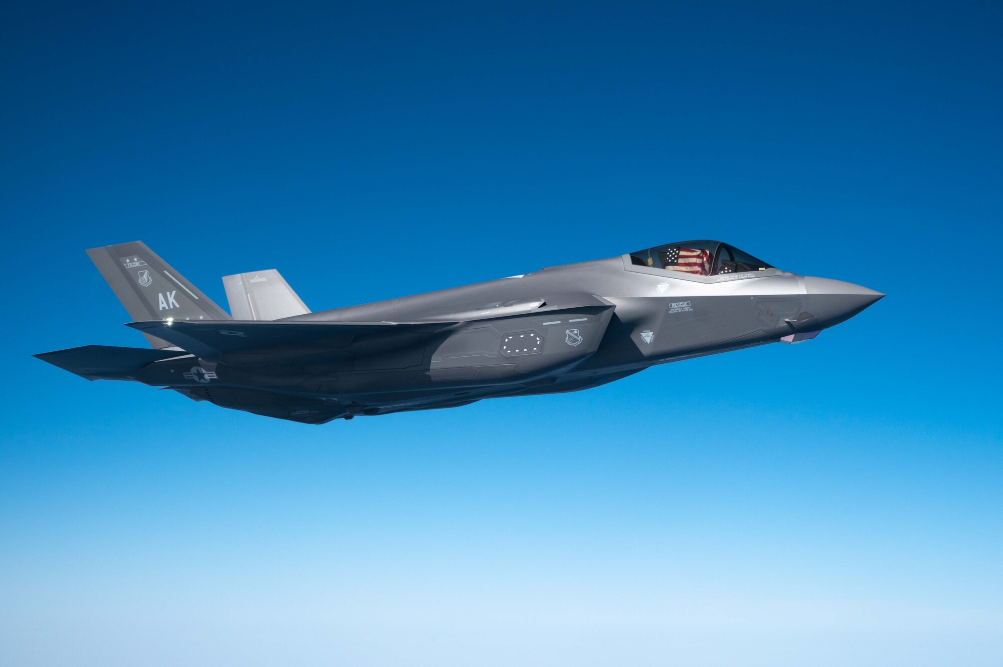 A jet flies alongside an aircraft