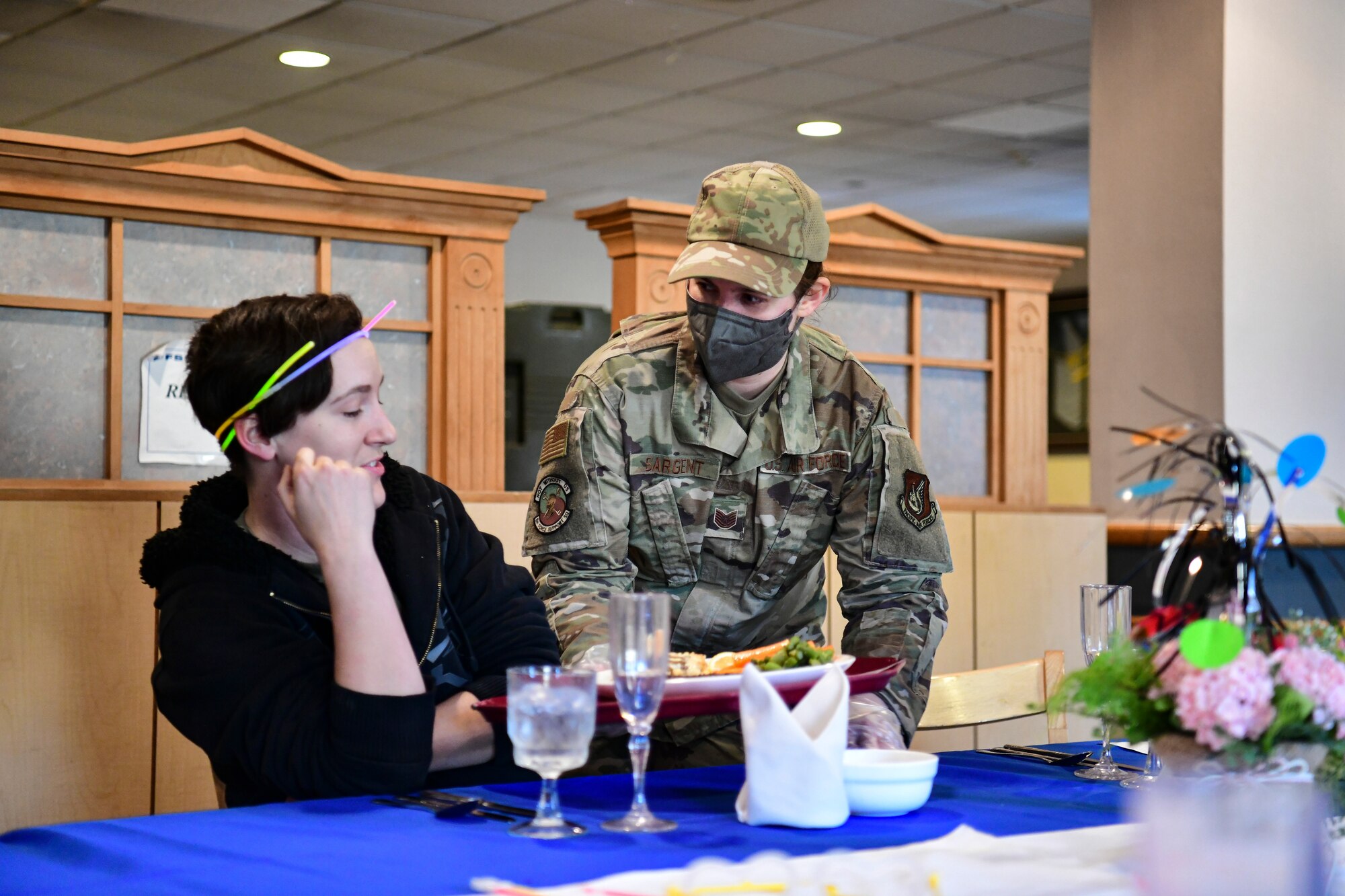 An Airman caters a meal during a celebration.