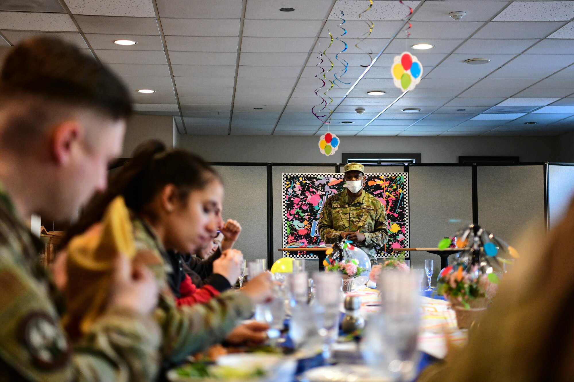 An Airman speaking during a celebration.