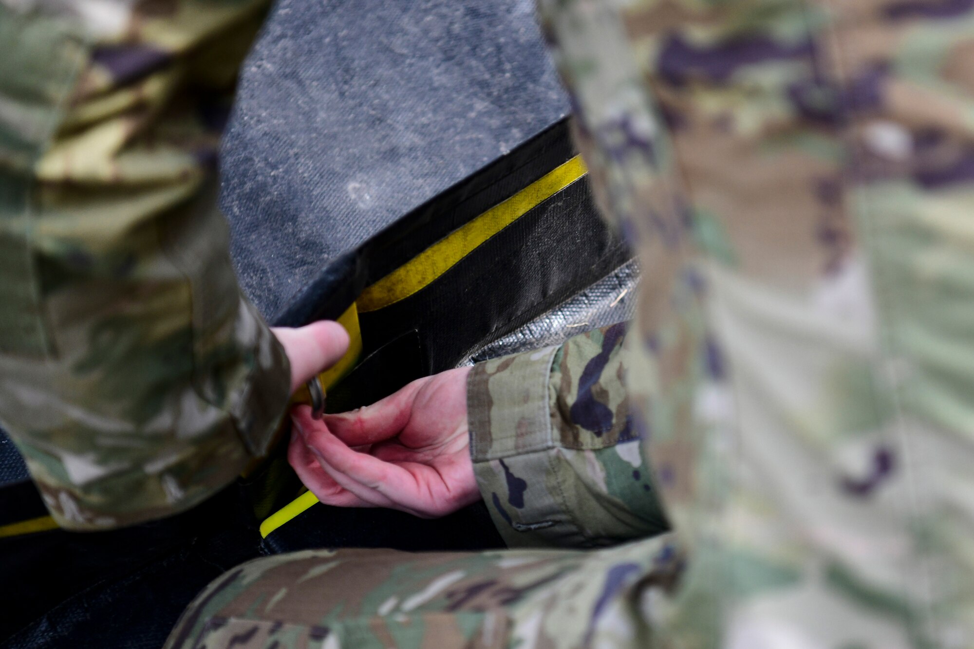 An Airman assemble a decon shelter.