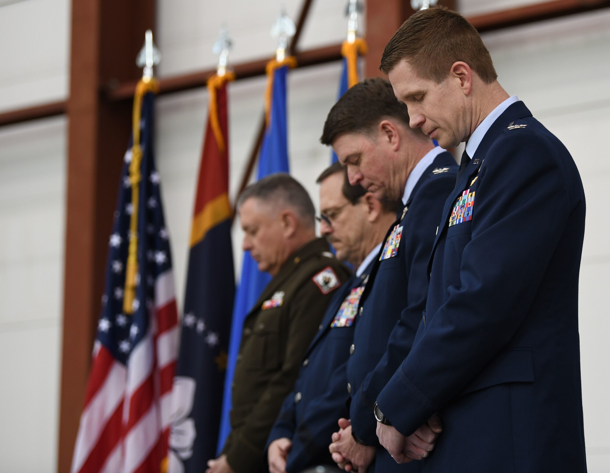 Maj. Gen. Janson D. Boyles, adjutant general of the Mississippi National Guard, Maj. Gen. Billy M. Nabors, assistant adjutant general and commander, Mississippi Air National Guard, Col. Tommy F. Tillman, Jr., outgoing commander, 172nd Airlift Wing, and Col. Britt A. Watson, incoming wing commander, bow for prayer in a change of command ceremony at Thompson Field, Jackson, Mississippi, Feb. 6, 2022.