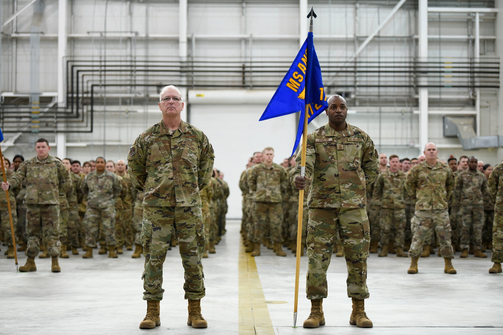 Col. Lynn Cole, vice commander of the 172nd Airlift Wing, and SMSgt. Ira Hamilton, wing first sergeant, direct the formation at the change of command ceremony welcoming Col. Britt A. Watson as the new commander at Thompson Field, Jackson, Mississippi, Feb. 6, 2022.