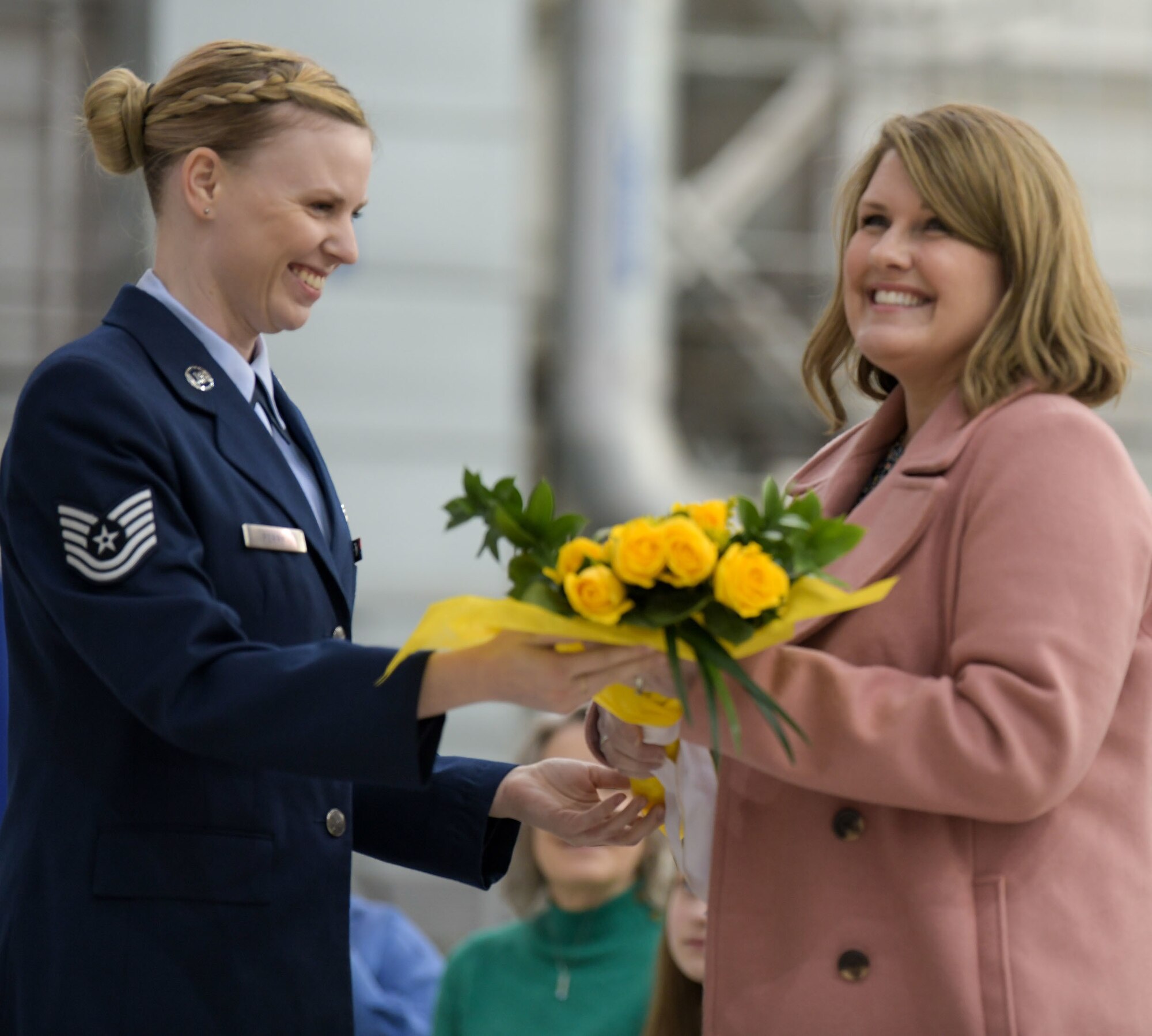 Kelli Watson, wife of incoming commander, Col. Britt A. Watson, receives a bouquet of yellow roses at the 172nd Airlift Wing change of command ceremony Feb. 6, 2022.