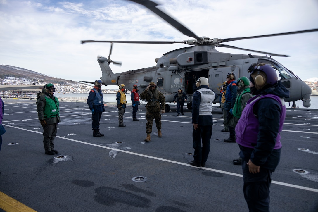 Italian Navy Contrammiraglio Valentino Rinaldi and U.S. Marine Corps Brig. Gen. Anthony Henderson, commanding general, 2d Marine Expeditionary Brigade, depart the Italian Navy Aircraft Carrier Giuseppe Garibaldi to tour the training areas in an Italian MH101 in preparation for Exercise Cold Response 2022, March 12, 2022, Narvik, Norway. Exercise Cold Response '22 is a biennial Norwegian national readiness and defense exercise that takes place across Norway, with participation from each of its military services, as well as from 26 additional North Atlantic Treaty Organization allied nations and regional partners. (U.S. Marine Corps photo by Pfc. Yiram Suarez Felix)