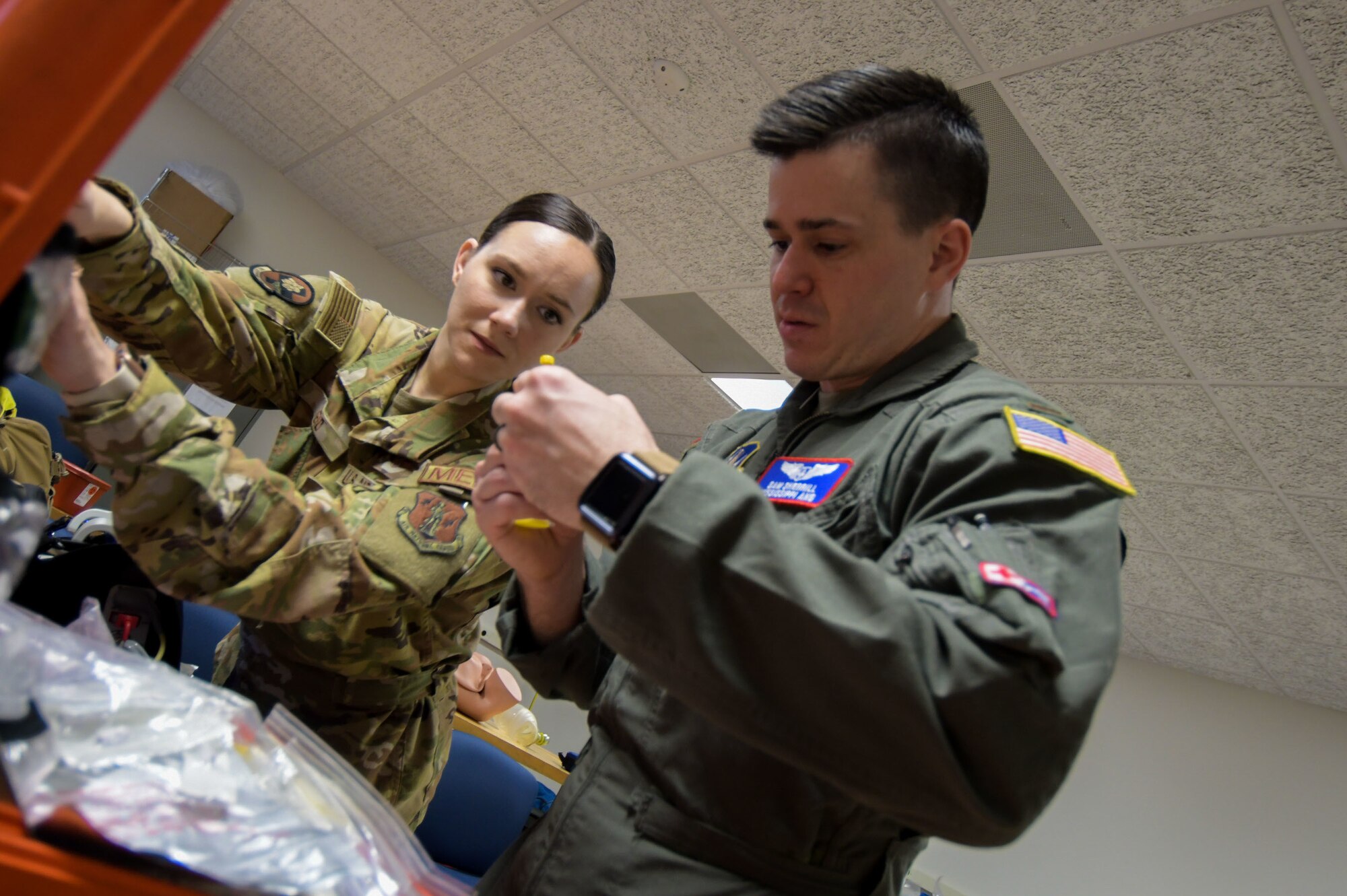 Senior Airman Abby Reid, a flight medical technician, and 2nd Lt. Sam Sherrill, a flight nurse with the 183rd Aeromedical Evacuation Squadron, 172nd Airlift Wing, Jackson, Mississippi, inspect trauma response gear March 6, 2022.