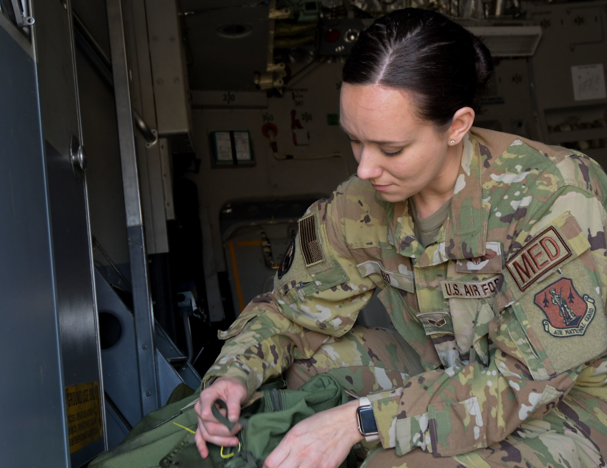 Senior Airman Abby Reid, a flight medical technician with the 183rd Aeromedical Evacuation Squadron, 172nd Airlift Wing, Jackson, Mississippi, prepares her kit aboard a C-17 Globemaster III March 6, 2022.