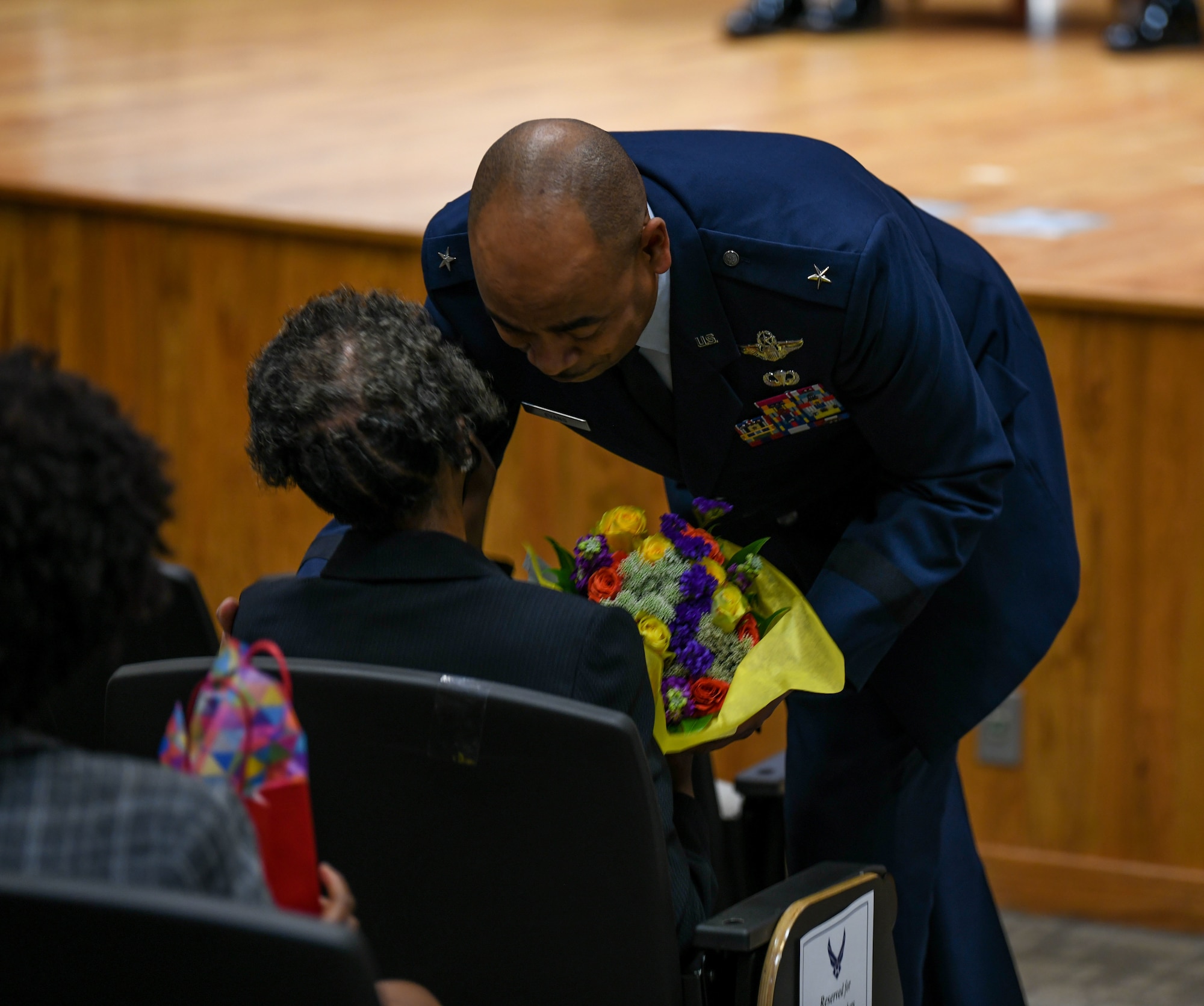Brig. Gen. Edward H. Evans, Jr., chief of staff, Mississippi Air National Guard, and the first Mississippi Air National Guard member to be promoted to the rank of brigadier general, presents his mother with a bouquet during his promotion ceremony at Mississippi National Guard Joint Force Headquarters, Jackson, Mississippi, March 5, 2022.