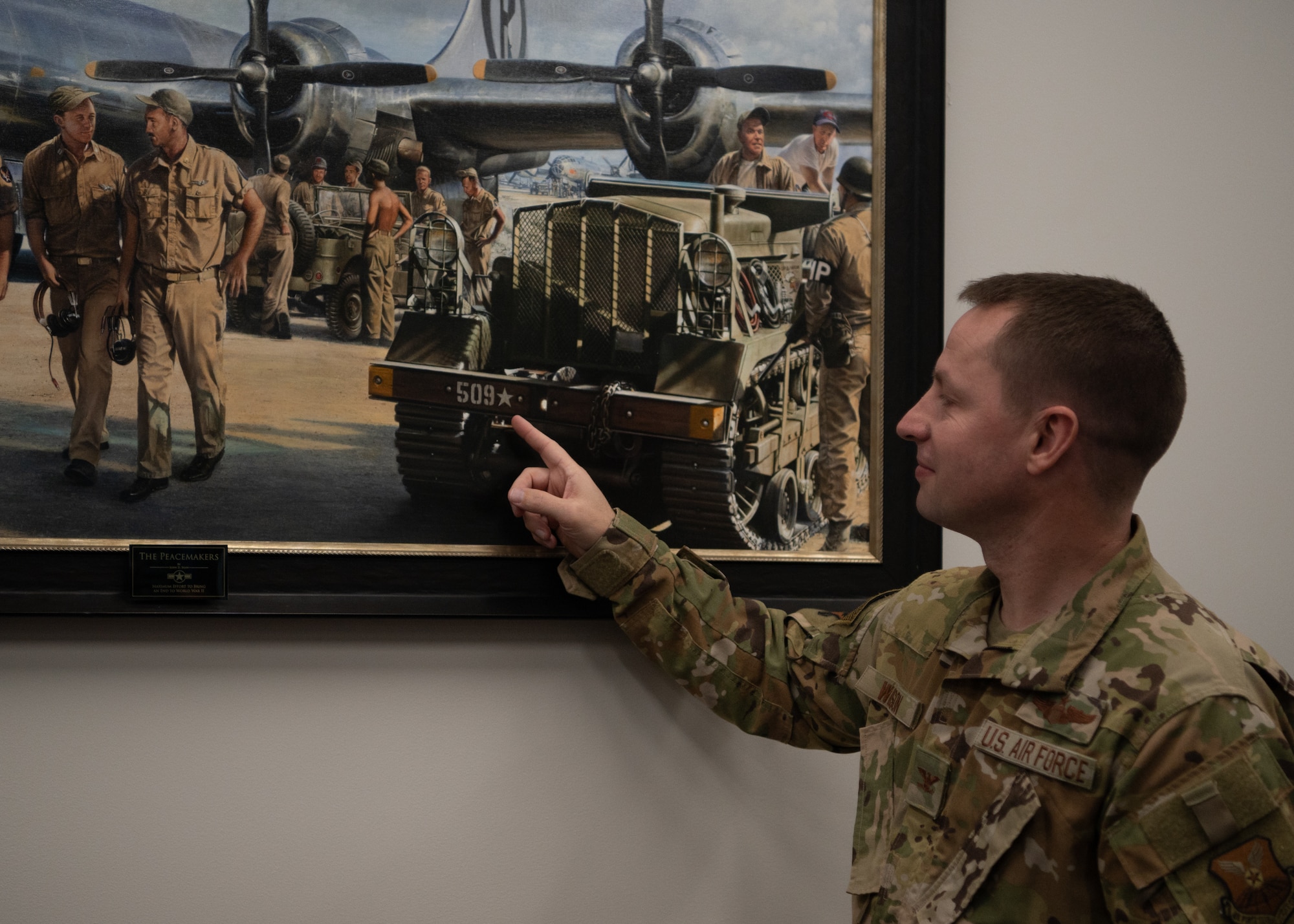 Col. Kyle Wilson points at the bumper of the M2 High Speed Tractor.