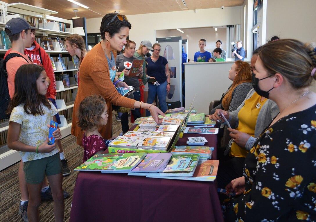 Sissi Knotts of Fort Irwin and her children, Sarah, Julia, Rachel and Ethan pick out some free books at the new Fort Irwin Library following a March 9 ribbon-cutting ceremony signifying the grand opening of the library. The U.S. Army Corps of Engineers Los Angeles District managed the construction of the facility.