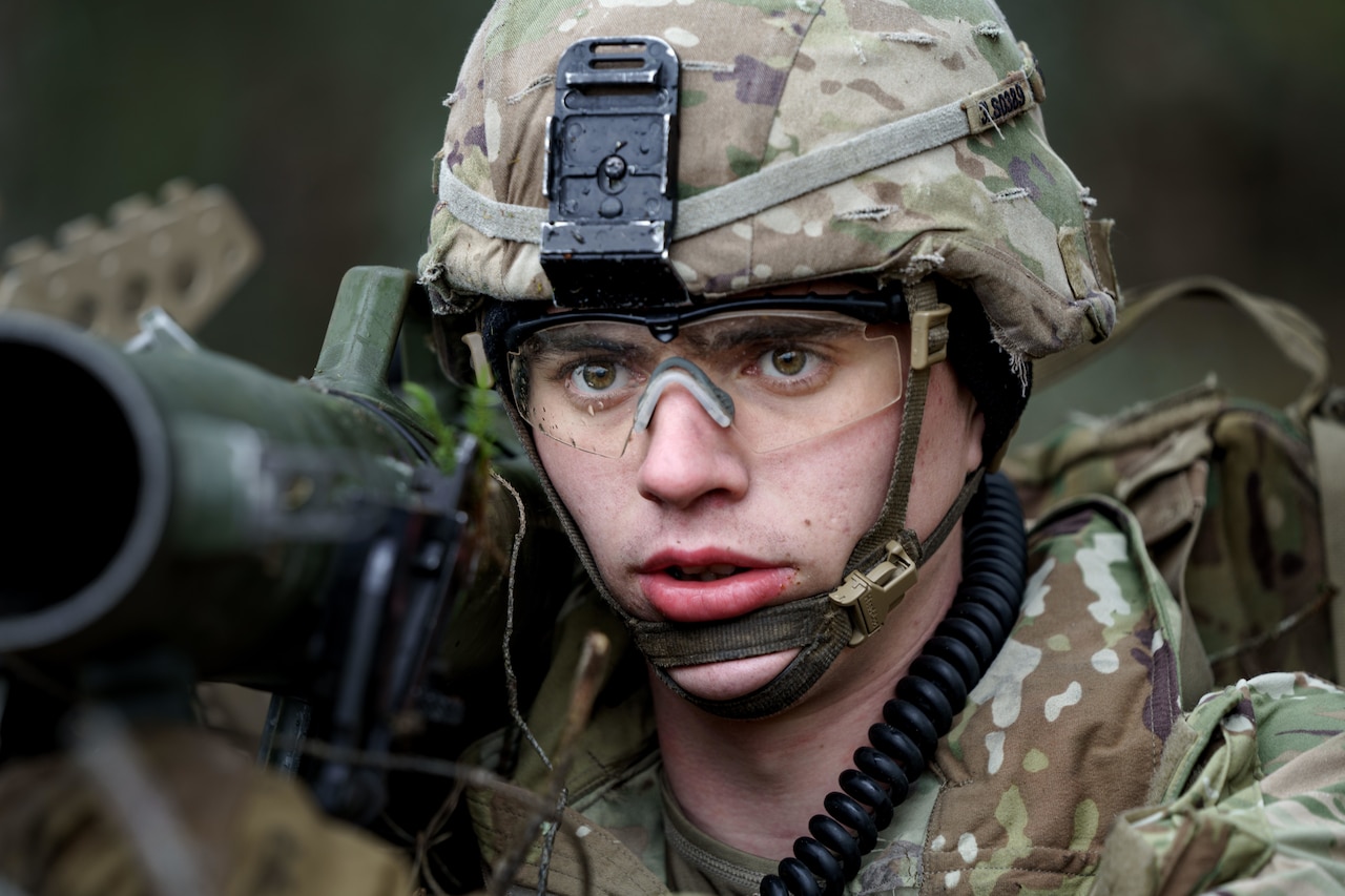 A soldier holds a weapon.