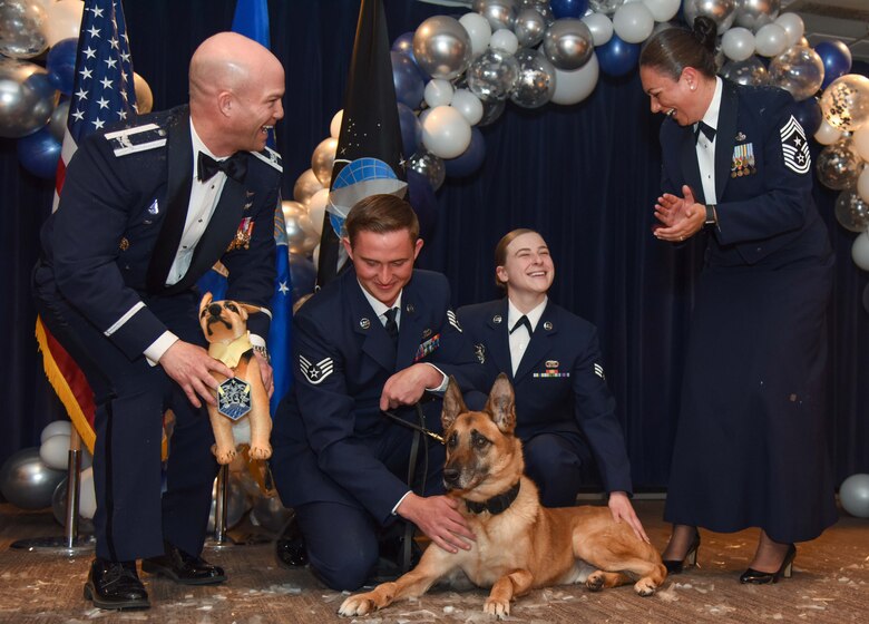 U.S. Air Force Col. Shay Warakomski, Peterson-Schriever Garrison commander, presents U.S. Air Force Military Working Dog Rrudy, 21st Security Forces Squadron MWD, with the “Very Best Boy” award at Peterson Space Force Base, Colorado, Mar. 11, 2022.