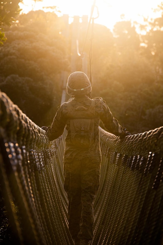 Sgt. Maj. Aaron Colling, III MIG Sgt. Major, III MEF Information Group, crosses a rope bridge during a Jungle Warfare Training Center endurance course, March 3, 2022, at Camp Gonsalves, Okinawa, Japan. Throughout the course, Marines learned how to traverse, survive, and thrive in the jungle. (Marine Corps photo by Cpl. Zachary Sarvey)