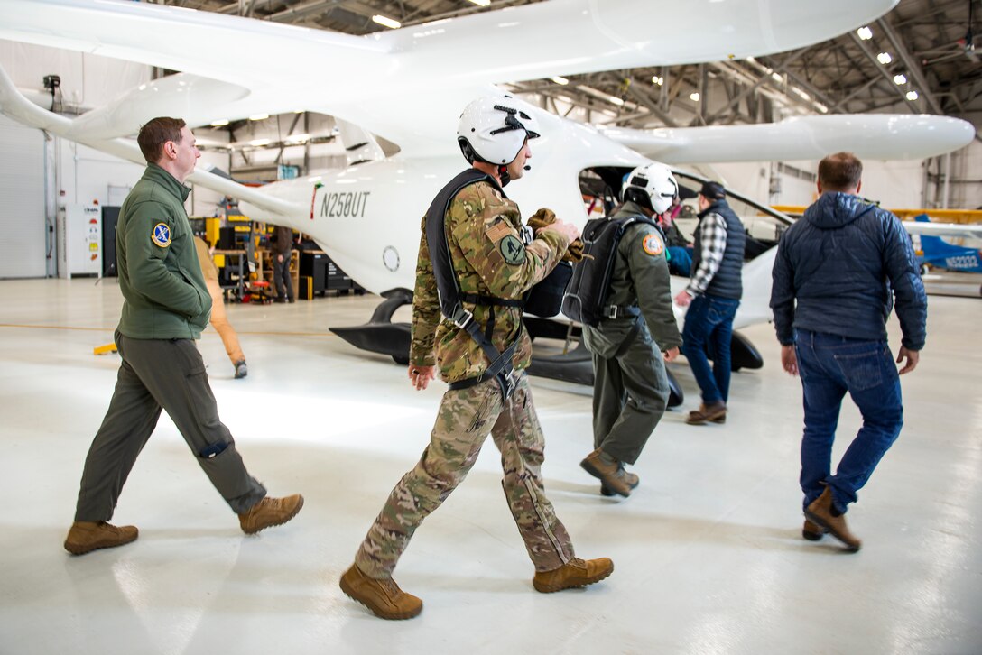 U.S. Air Force and BETA Technologies team members walk toward an ALIA aircraft for a flight test. (BETA Technologies photo/Brian Jenkins)