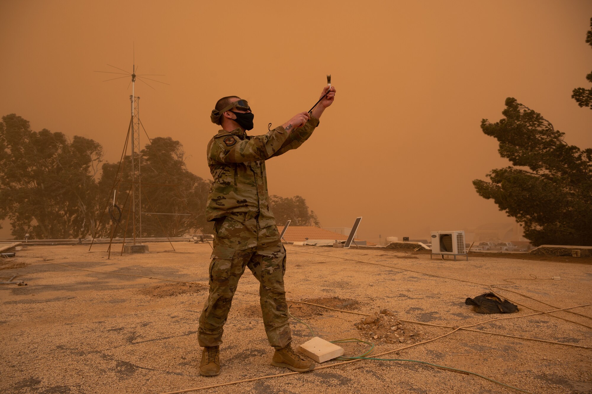 U.S. Air Force Tech. Sgt. Adam Gradyan, 332d Expeditionary Operations Support Squadron Weather Flight chief, uses a hand-held wind and weather meter during a dust storm at an undisclosed location in Southwest Asia, March 3, 2022. The 332d EOSS Weather Flight delivers customized meteorological support for the 332d Air Expeditionary Wing's varied structural and agency sensitivities.
(U.S. Air Force photo by Tech. Sgt. Lauren M. Snyder)