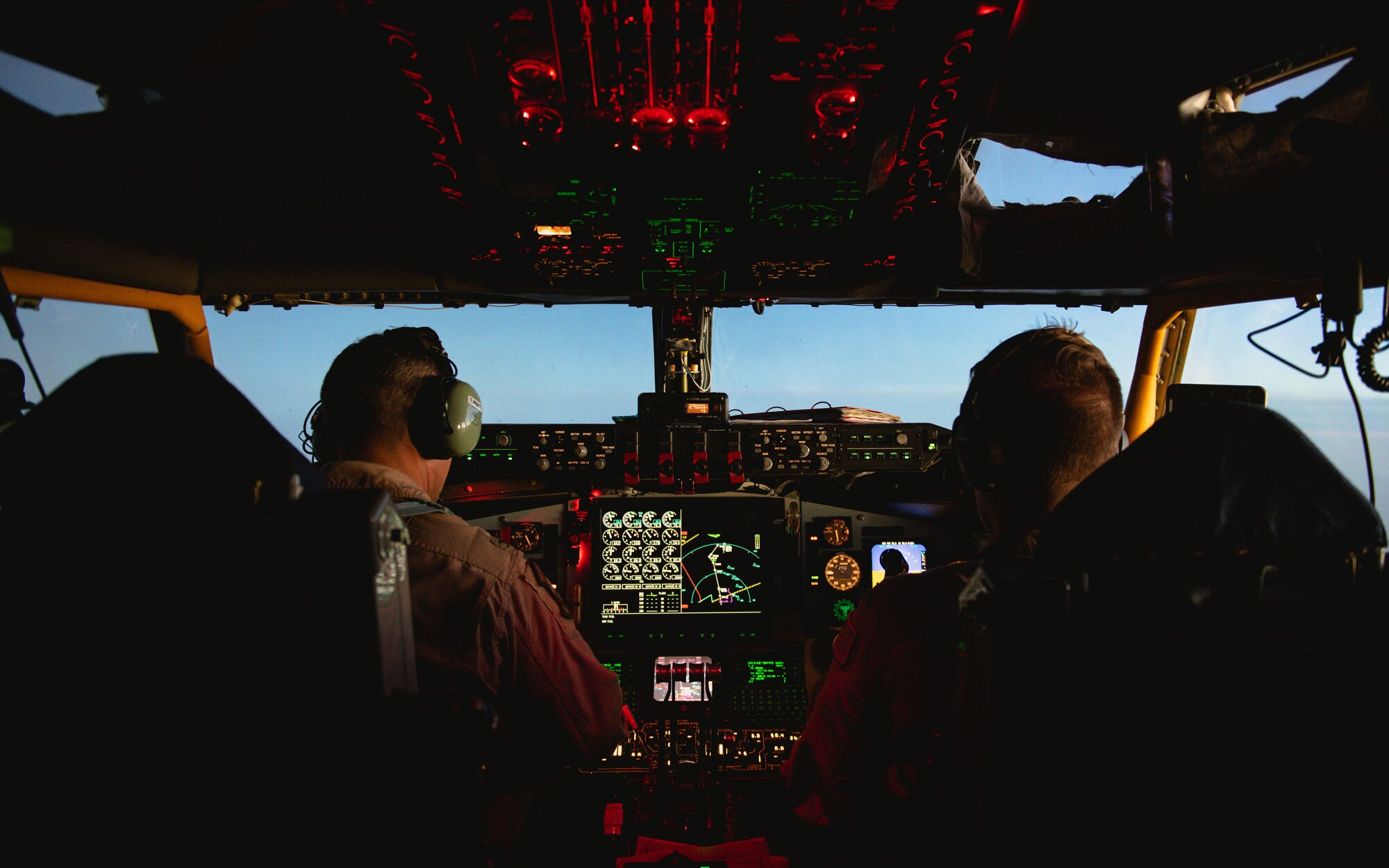 Pilots in a KC-135 cockpit.
