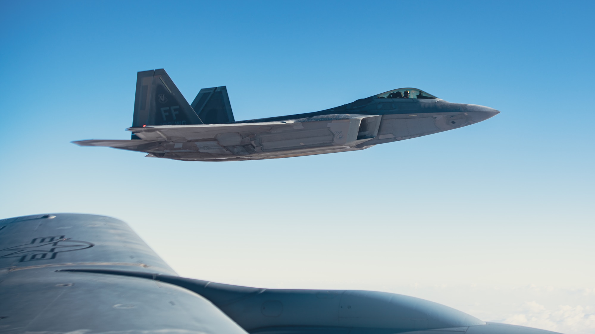 Raptor flies next to refueling aircraft.