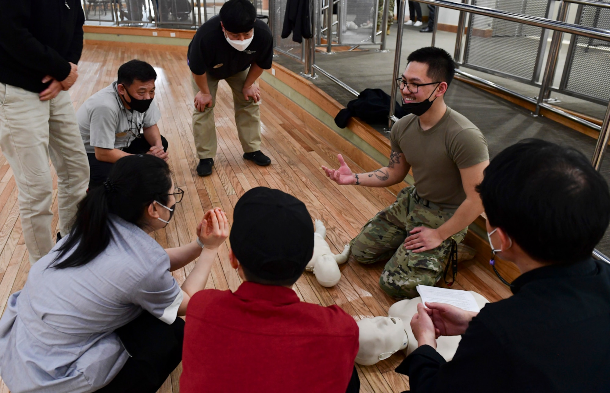 Senior Airman Nathanial Cruz, 51st Medical Group medical technician, teaches the basic practices of cardiopulmonary resuscitation (CPR) to civilian employees at Osan Air Base, Republic of Korea on March 9, 2022. The CPR course provided annual training for base exchange employees, food service workers and first responders.