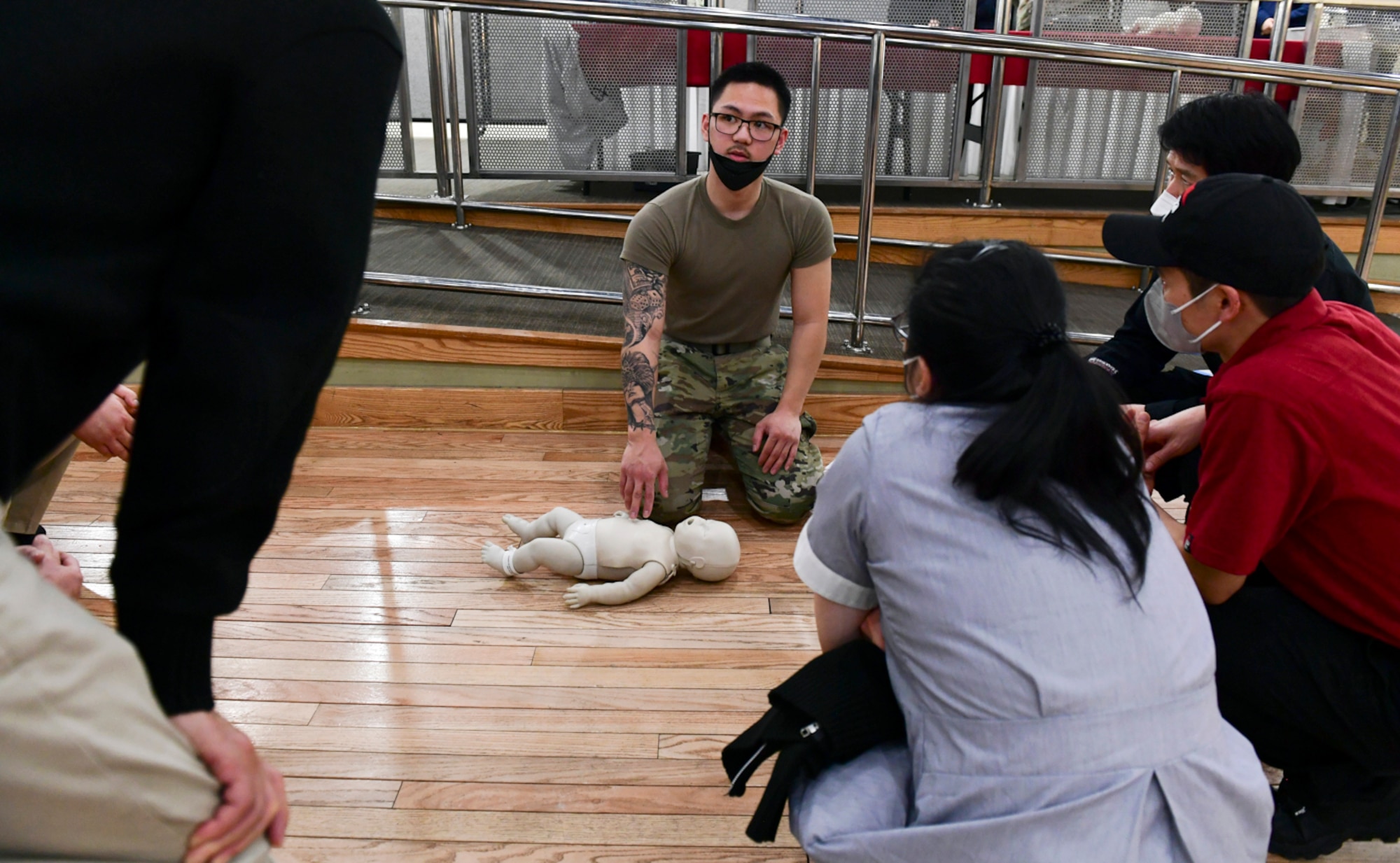 Senior Airman Nathanial Cruz, 51st Medical Group medical technician, teaches the basic practices of cardiopulmonary resuscitation (CPR) to civilian employees at Osan Air Base, Republic of Korea on March 9, 2022. The CPR course provided annual training for base exchange employees, food service workers and first responders.