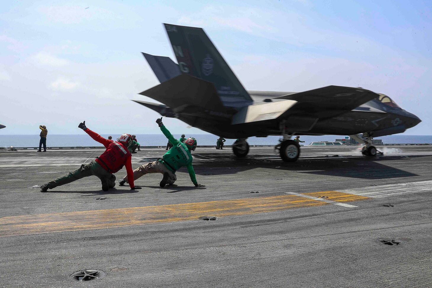 PHILIPPINE SEA (March 15, 2022) Sailors signal an F-35C Lightning II, assigned to the "Black Knights" of Marine Fighter Attack Squadron (VMFA) 314, as it launches from the flight deck of the Nimitz-class aircraft carrier USS Abraham Lincoln (CVN 72). Abraham Lincoln Strike Group is on a scheduled deployment in the U.S. 7th Fleet area of operations to enhance interoperability through alliances and partnerships while serving as a ready-response force in support of a free and open Indo-Pacific region. (U.S. Navy photo by Mass Communication Specialist 3rd Class Javier Reyes)
