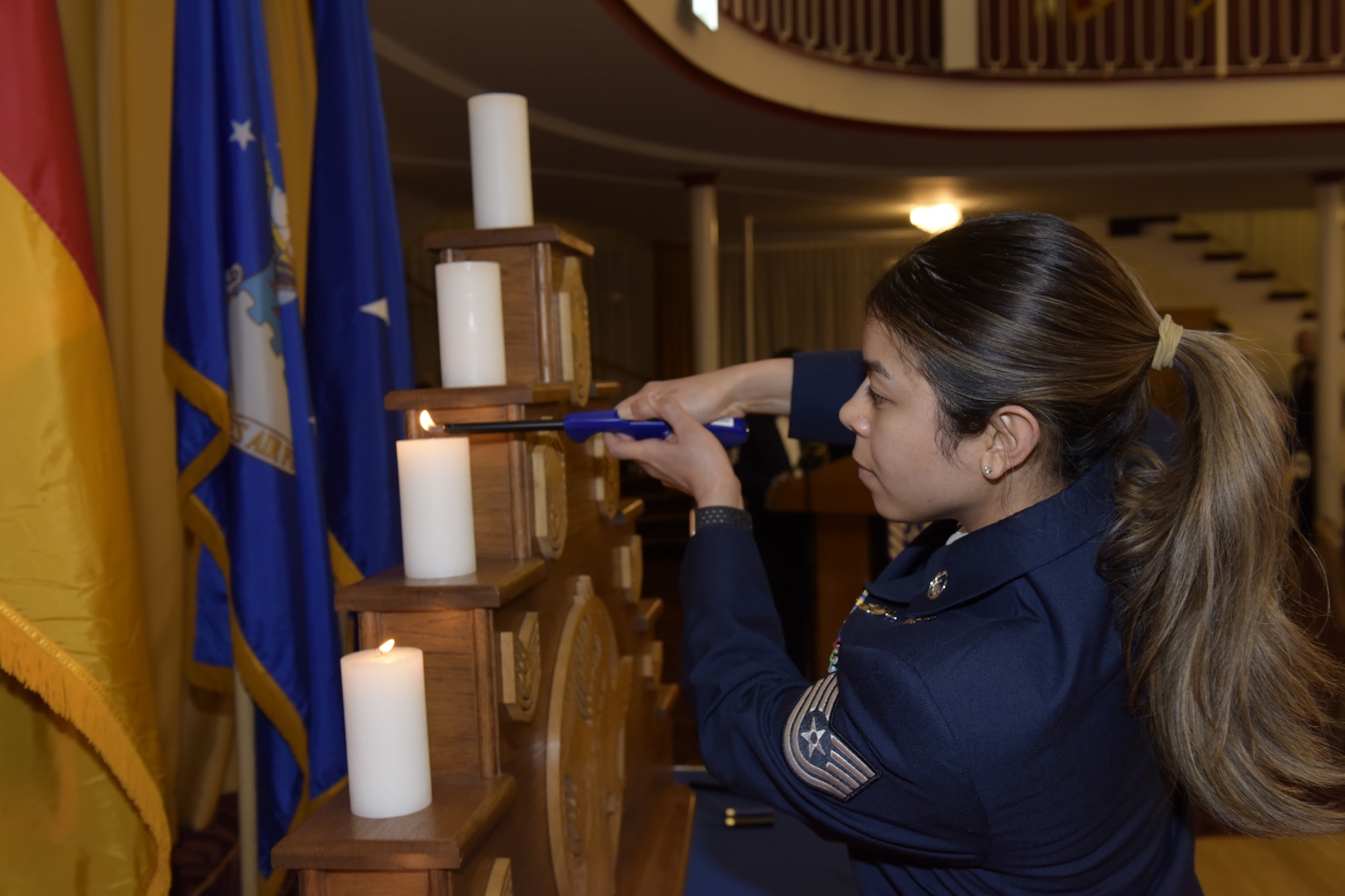 Woman lights a candle