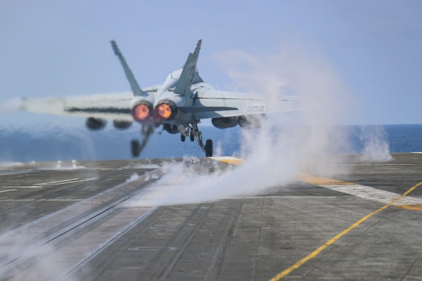 PHILIPPINE SEA (March 15, 2022) An F/A-18E Super Hornet, assigned to the "Tophatters" of Strike Fighter Squadron (VFA) 14, launches from the flight deck of the Nimitz-class aircraft carrier USS Abraham Lincoln (CVN 72). Abraham Lincoln Strike Group is on a scheduled deployment in the U.S. 7th Fleet area of operations to enhance interoperability through alliances and partnerships while serving as a ready-response force in support of a free and open Indo-Pacific region. (U.S. Navy photo by Mass Communication Specialist 3rd Class Javier Reyes)