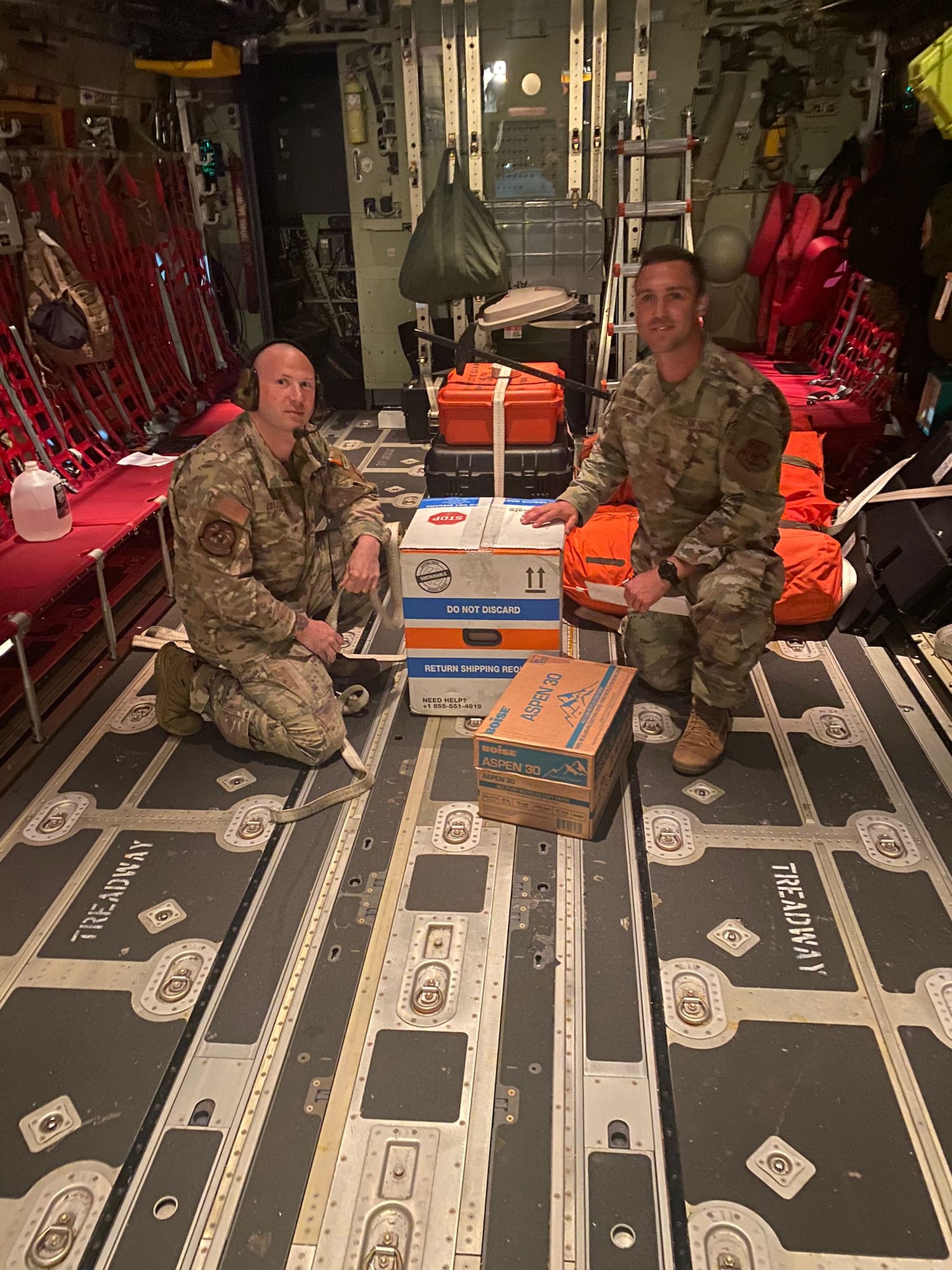 New York Air National Guard’s 106th Rescue Wing Staff Sgt. Brian M. Cotter, a 102nd Rescue Squadron Loadmaster, and Tech. Sgt. John R. Andrejack, a 106th Medical Group bioenvironmental engineer, kneel next to a shipment of Covid-19 vaccines packaged for shipment from the 109th Airlift Wing, Scotia, NY, to the 106th, Westhampton Beach, NY, September 9, 2021. The 106th were out of vaccines prior to their regularly scheduled drill, however they were able to borrow 300 doses from the 109th. Using a 102nd Rescue Squadron previously scheduled training assignment, the Airmen were able to safely transport the vaccines to the base onboard their HC-130J Combat King II aircraft. (U.S. Air National Guard photo courtesy of the 106th Rescue Wing)