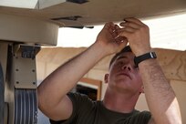 A U.S. Marine assigned to Headquarters Company, Regimental Combat Team (RCT) 7, sets up Secure Internet Protocol and Non-secure Internet Protocol Router Access Point (SNAP) satellite communications system on Camp Leatherneck, Helmand province, Afghanistan, April 24, 2013. (U.S. Marine Corps photo by Cpl. Alejandro Pena)