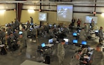 United States Army National Guard Soldiers and Airmen move swiftly through the Cyber City area of operation as Blue Team defenders during the Cyber Shield 2016 exercise at Camp Atterbury, IN, April 20, 2016. (Photo by SGT Stephanie A. Hargett, USA)